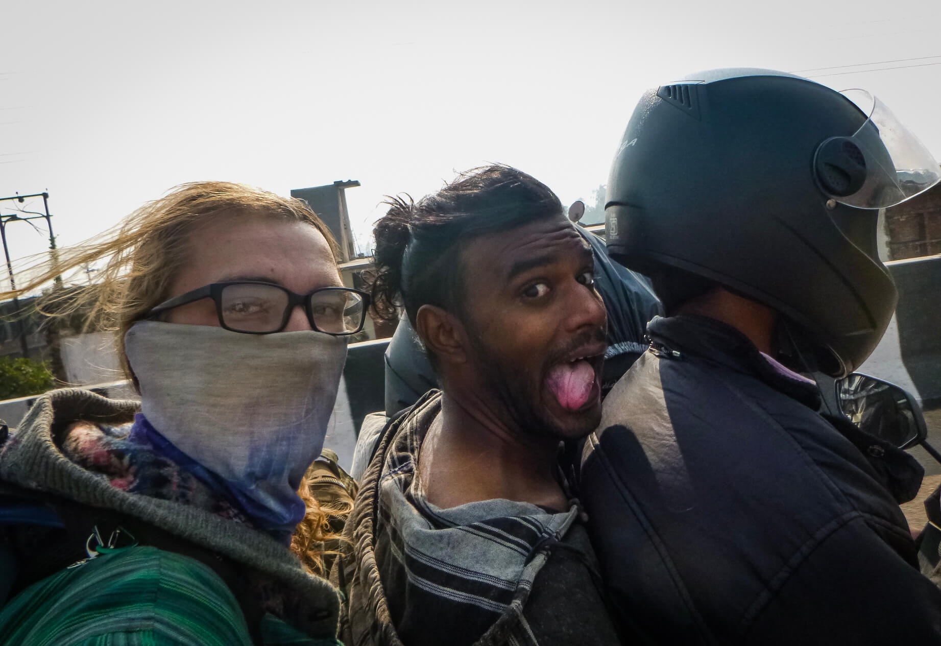 people hitchhiking on a motorbike